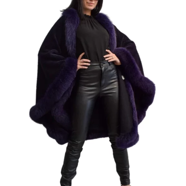 Woman with hands on hips wearing a purple cape
