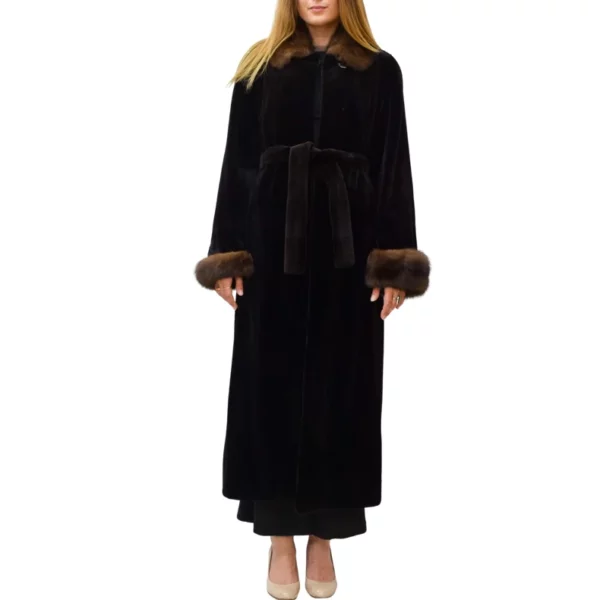 A woman wearing a black mink coat with a brown collar and cuffs