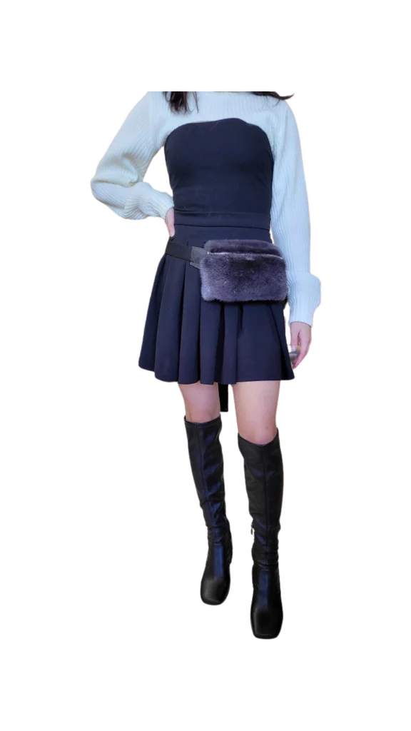 Woman poses with her hand on her hip while wearing a fur fanny pack