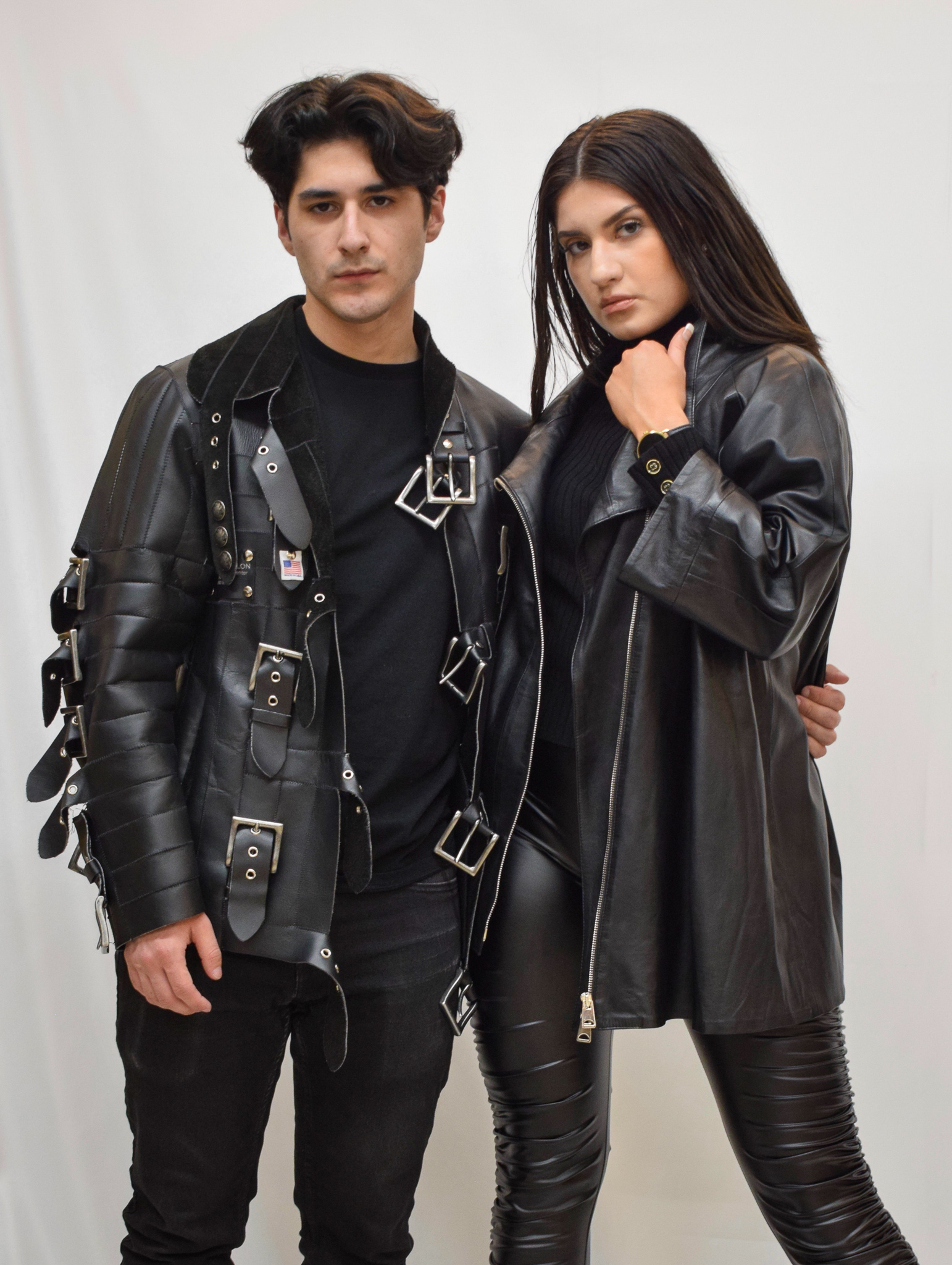 Man and woman posing together while wearing all black leather