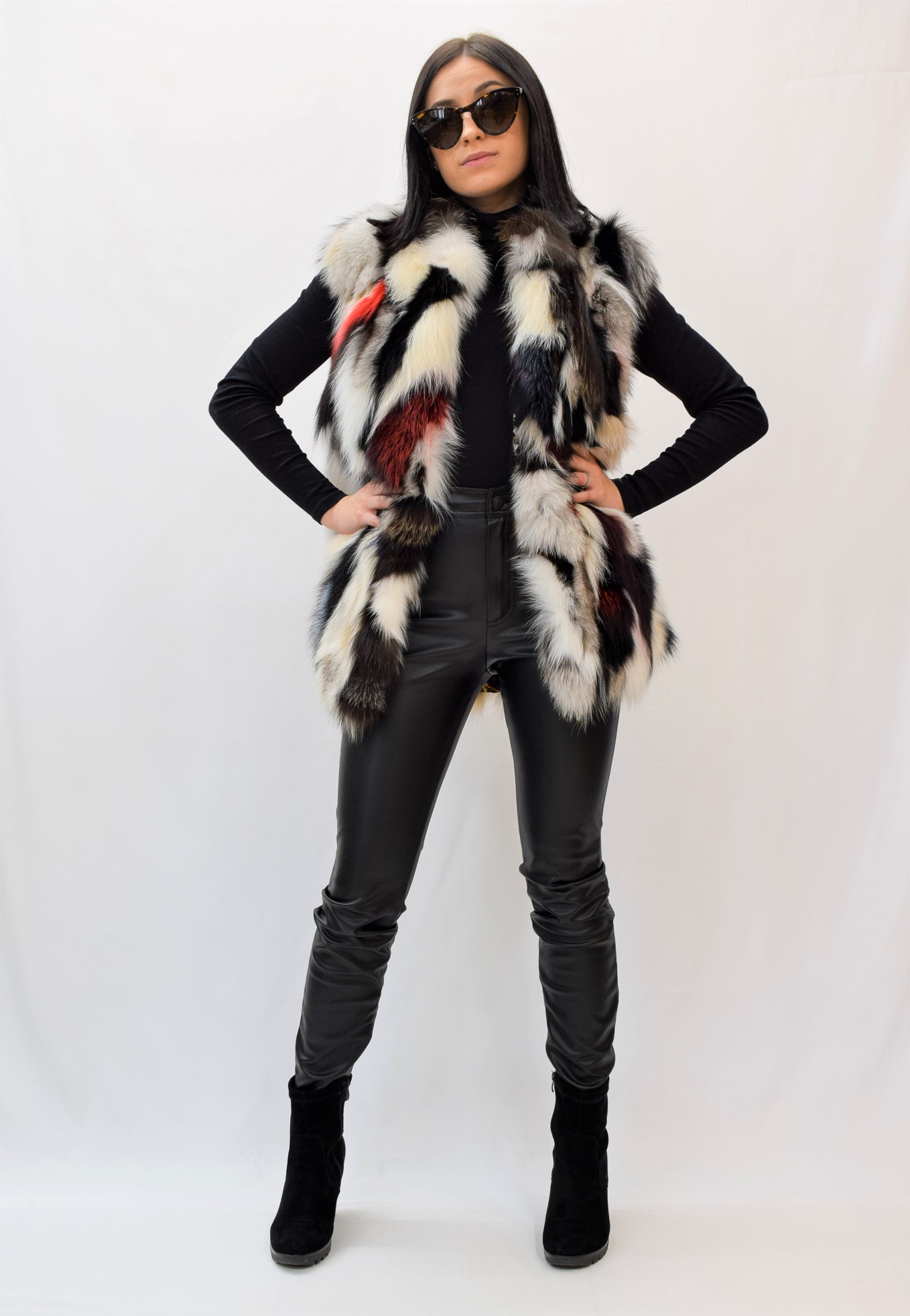 Woman with her hands on her hips while wearing a multicolor fur vest