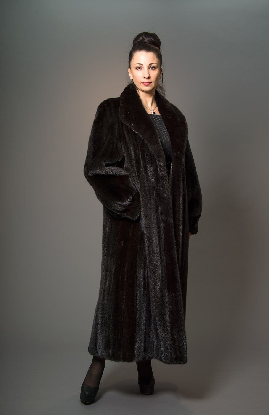 Woman wearing a long black mink coat